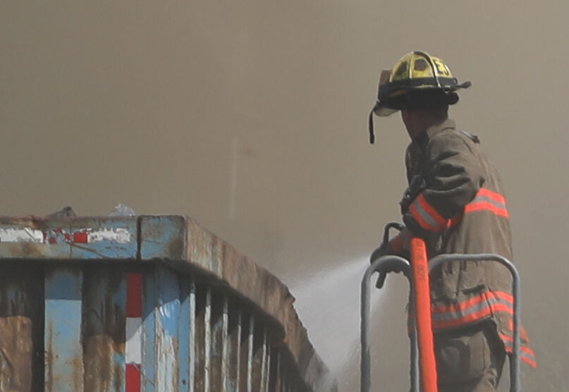 A Washington firefighter douses flames